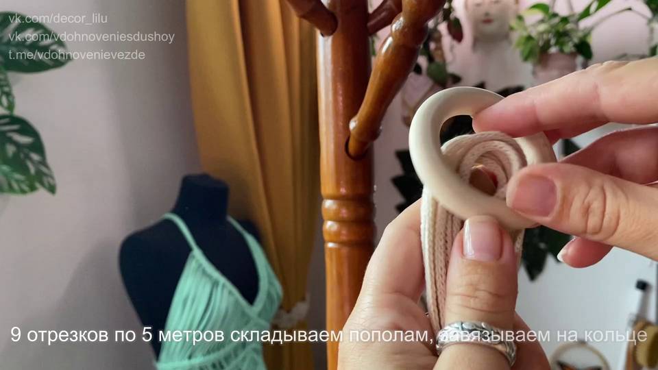 Руки закрепляют сложенный пополам хлопковый шнур на деревянном кольце